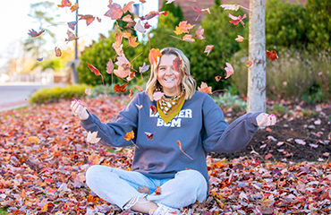 student with leaves