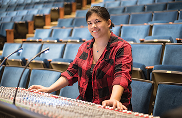 student with sound board