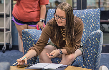 student studying in library